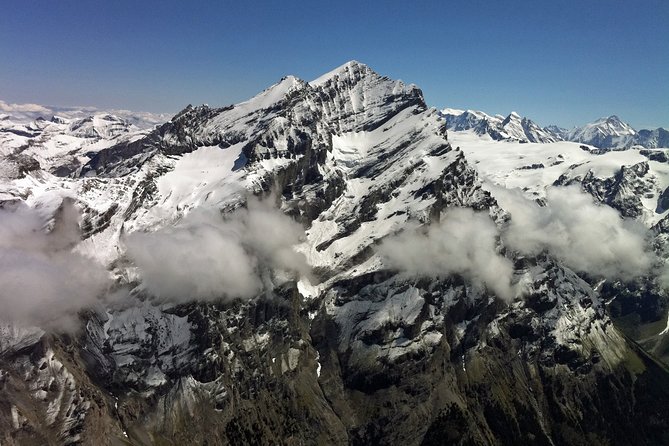 Private Swiss Alps helicopter tour over snow covered mountain peaks and glaciers - Eiger north face and the snowy wall effect near Grindelwald