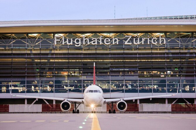 Private Transfer from Zurich Airport ZRH to Lucerne - Meeting in Zurich Arrivals with a TripTransfer sign